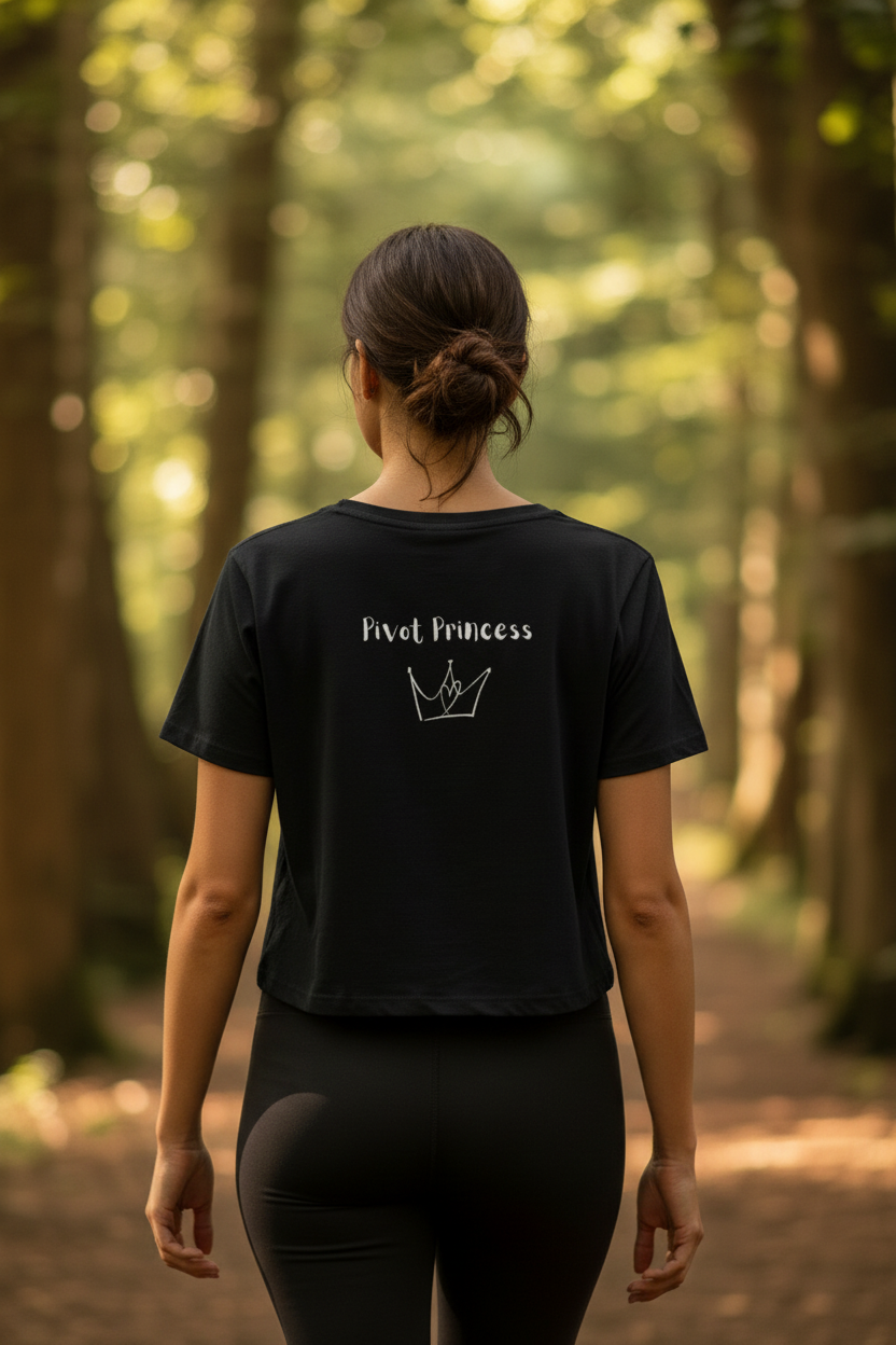 Back of black Pivot Princess crop tee – close-up forest setting