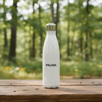 PAUSE. water bottle on an outdoor camp table