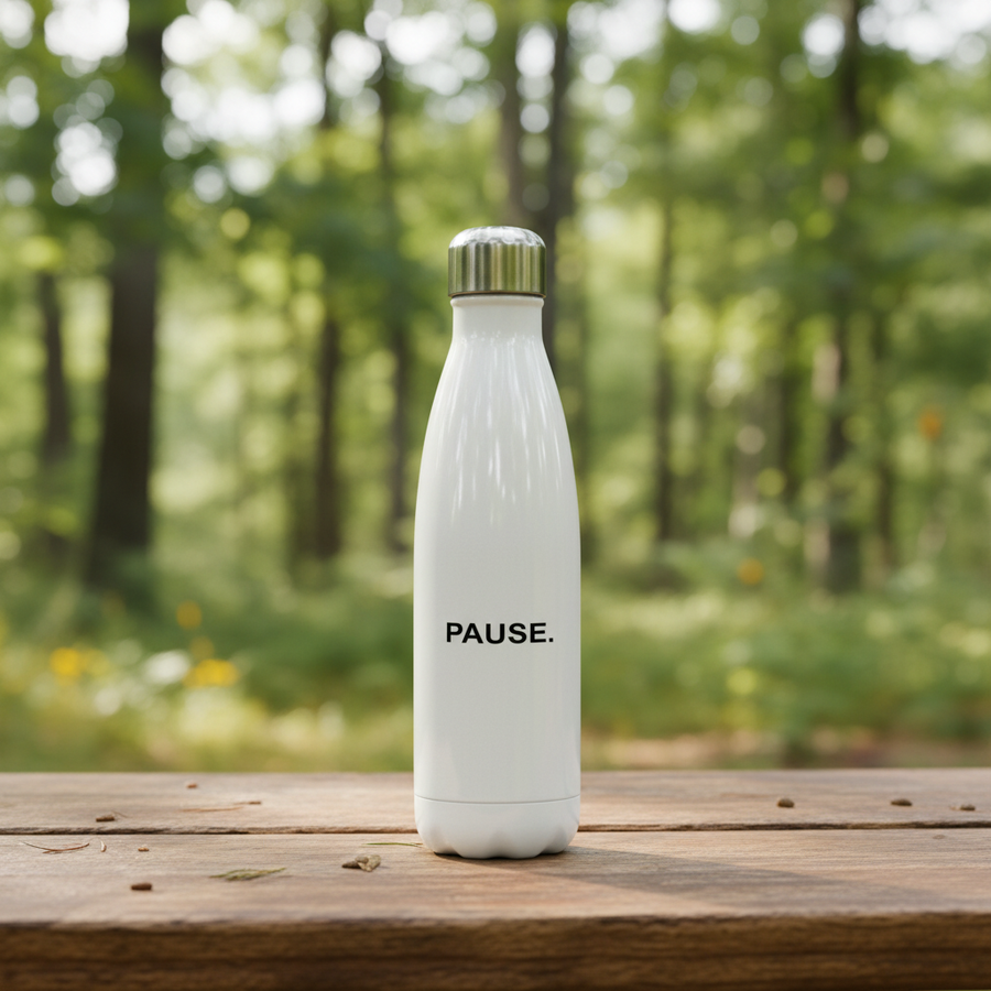 PAUSE. water bottle on an outdoor camp table